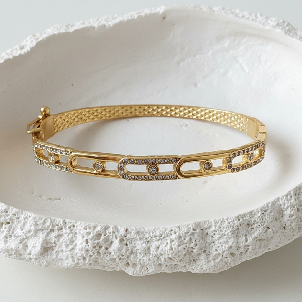 Quilted Mesh Pavé Oval Link Bangle flat lay in white shell tray