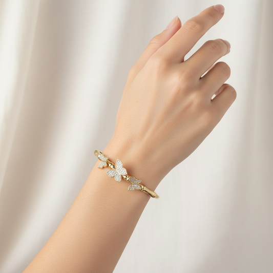 Woman wearing crystal butterfly bangle bracelet elegant gold bracelet for everyday wear