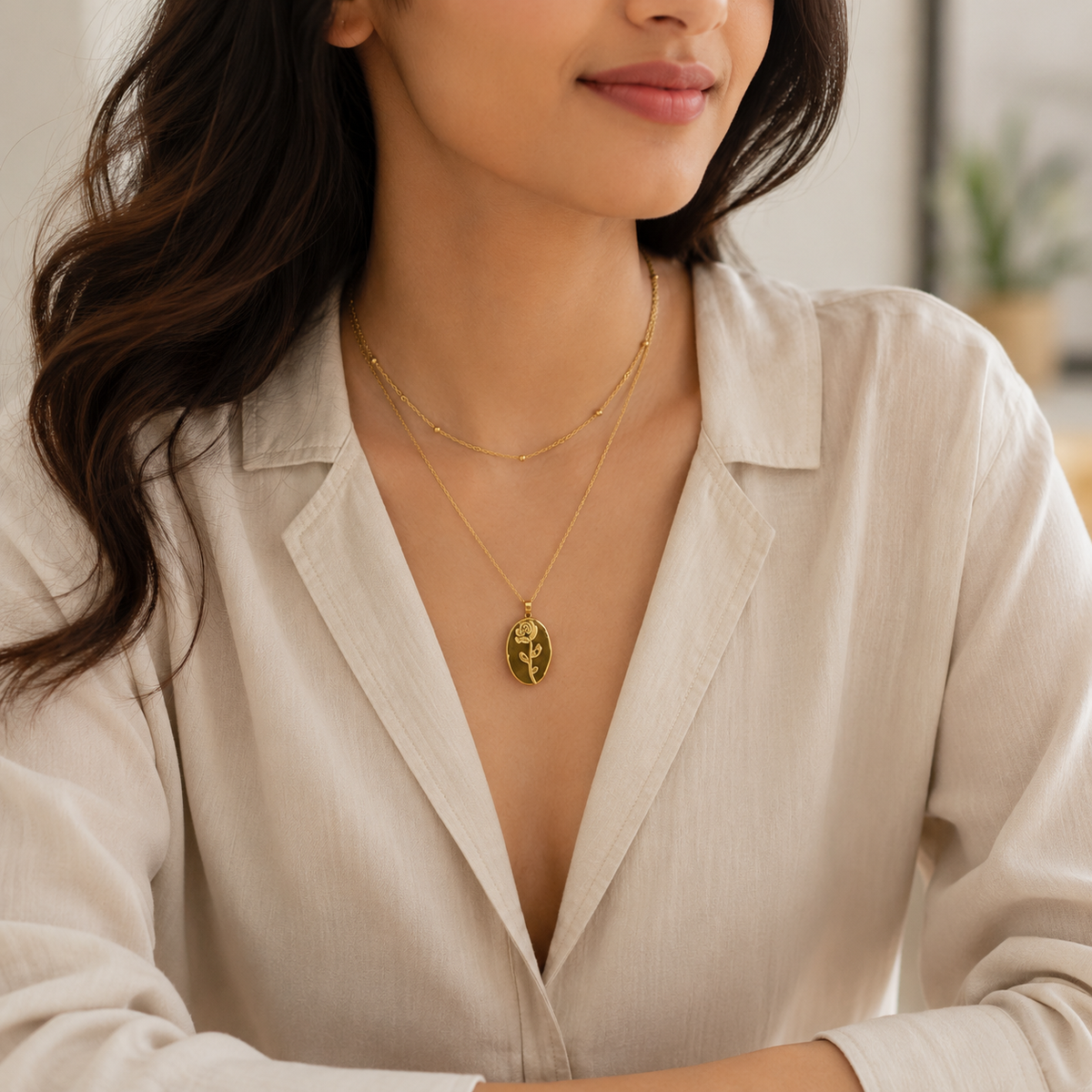 Gold oval pendant necklace layered with delicate chain