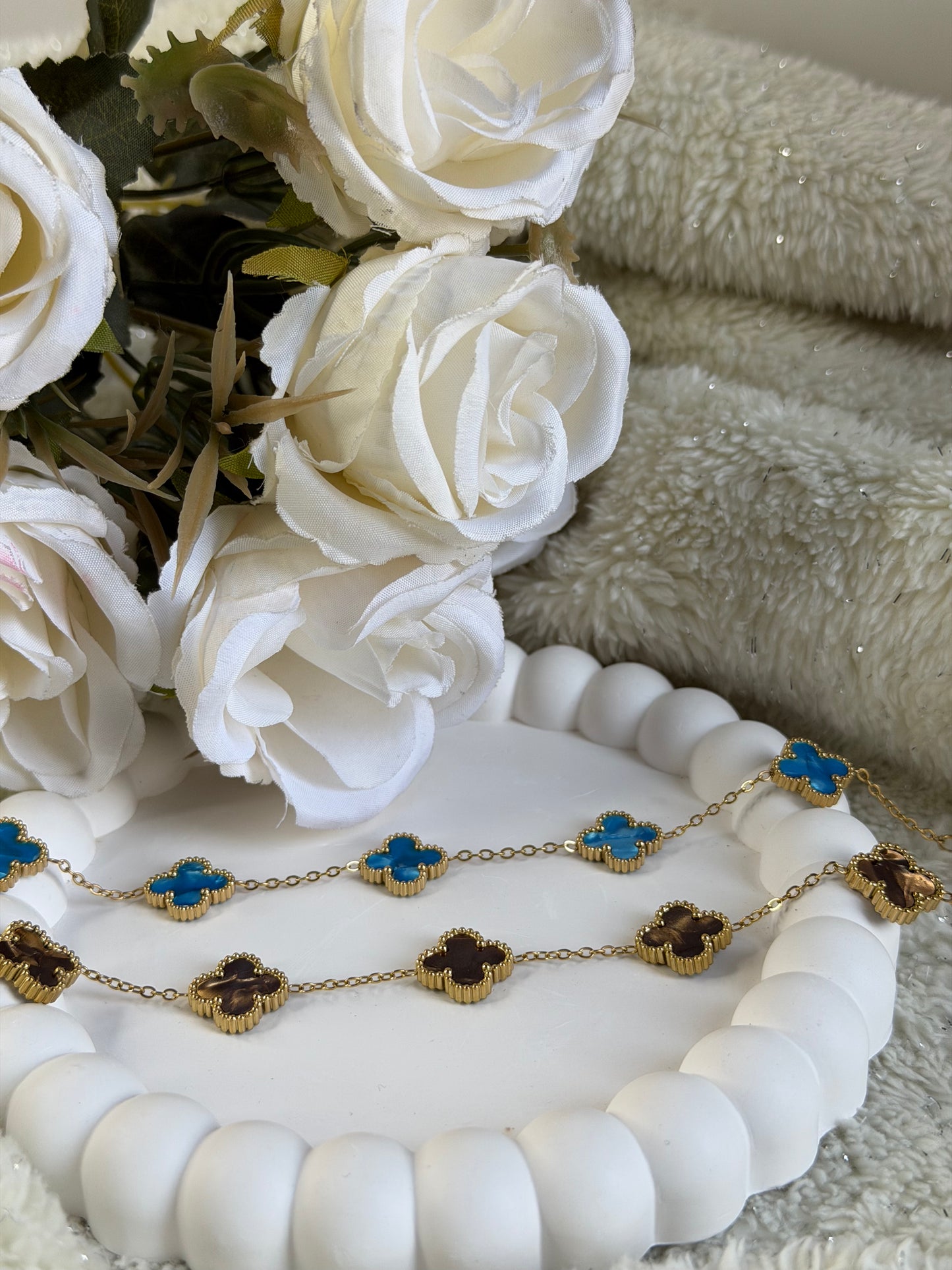 Woman wearing blue clover gold plated chain bracelet elegant everyday bracelet