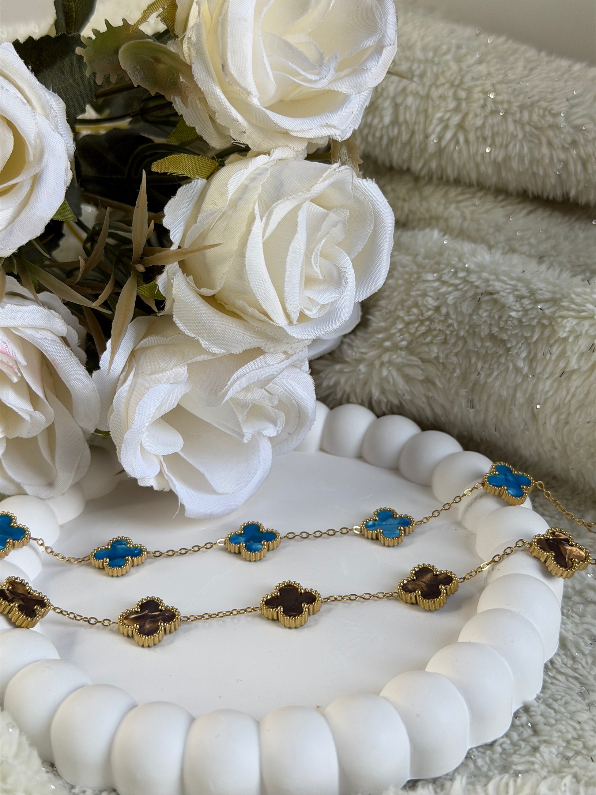 Woman wearing blue clover gold plated chain bracelet elegant everyday bracelet