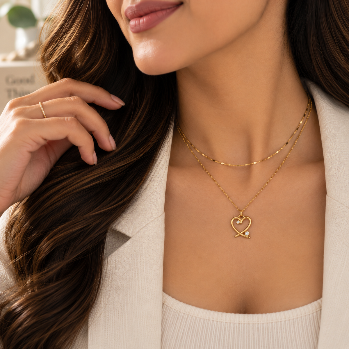 Amorette crystal heart necklace layered with a delicate gold-tone chain for everyday styling