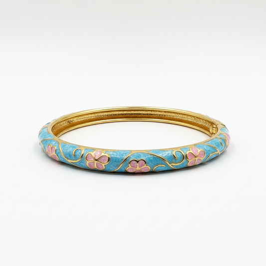 Angled side view of turquoise floral bangle