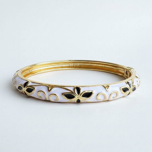 Angled side view of white enamel bracelet