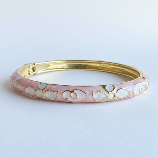 Pink petal gold plated floral enamel bracelet for women on white background