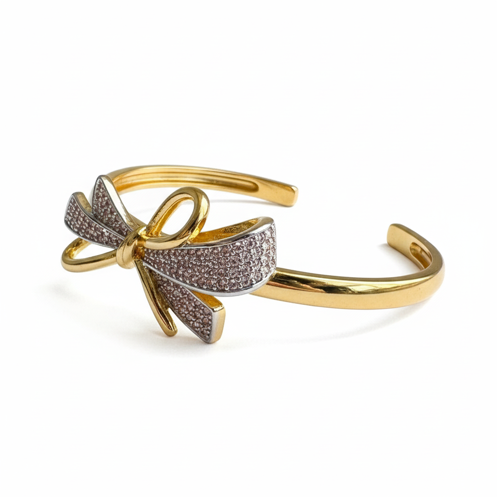 Crystal gold plated bow cuff bracelet for women on white background