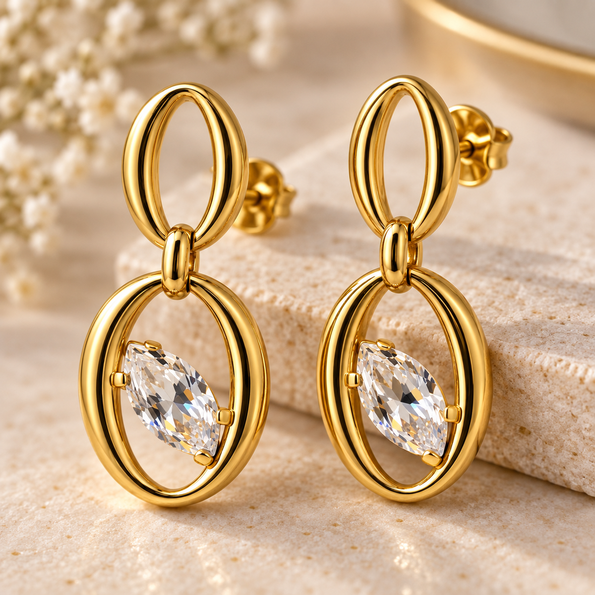 Close-up of Aveline Crystal Oval Drop Earrings showing marquise stone and polished gold-tone finish