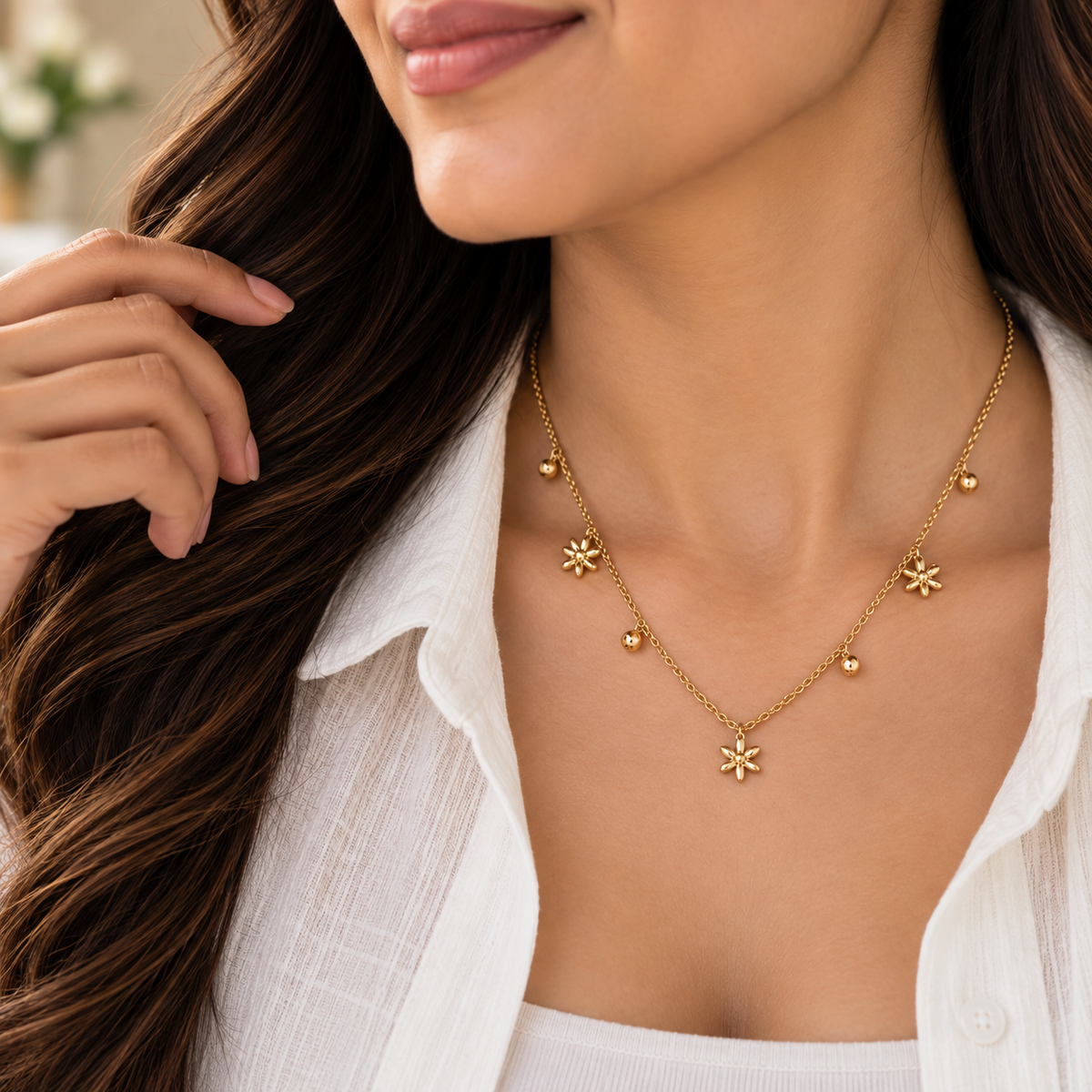 Woman wearing Aveline floral charm necklace with an elegant minimal outfit