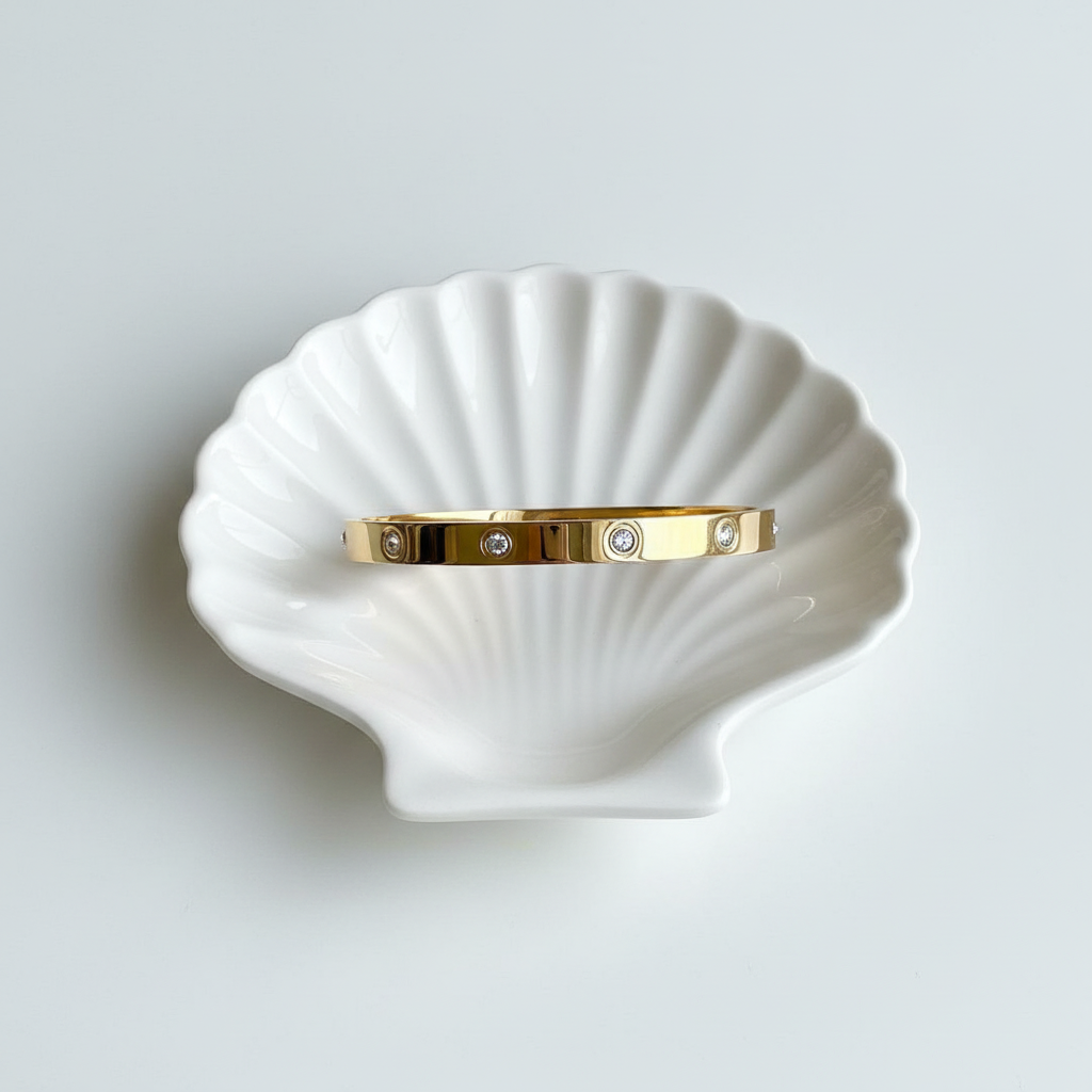 Crystal stud cartier style wide bangle bracelet flat lay minimal gold jewellery for women