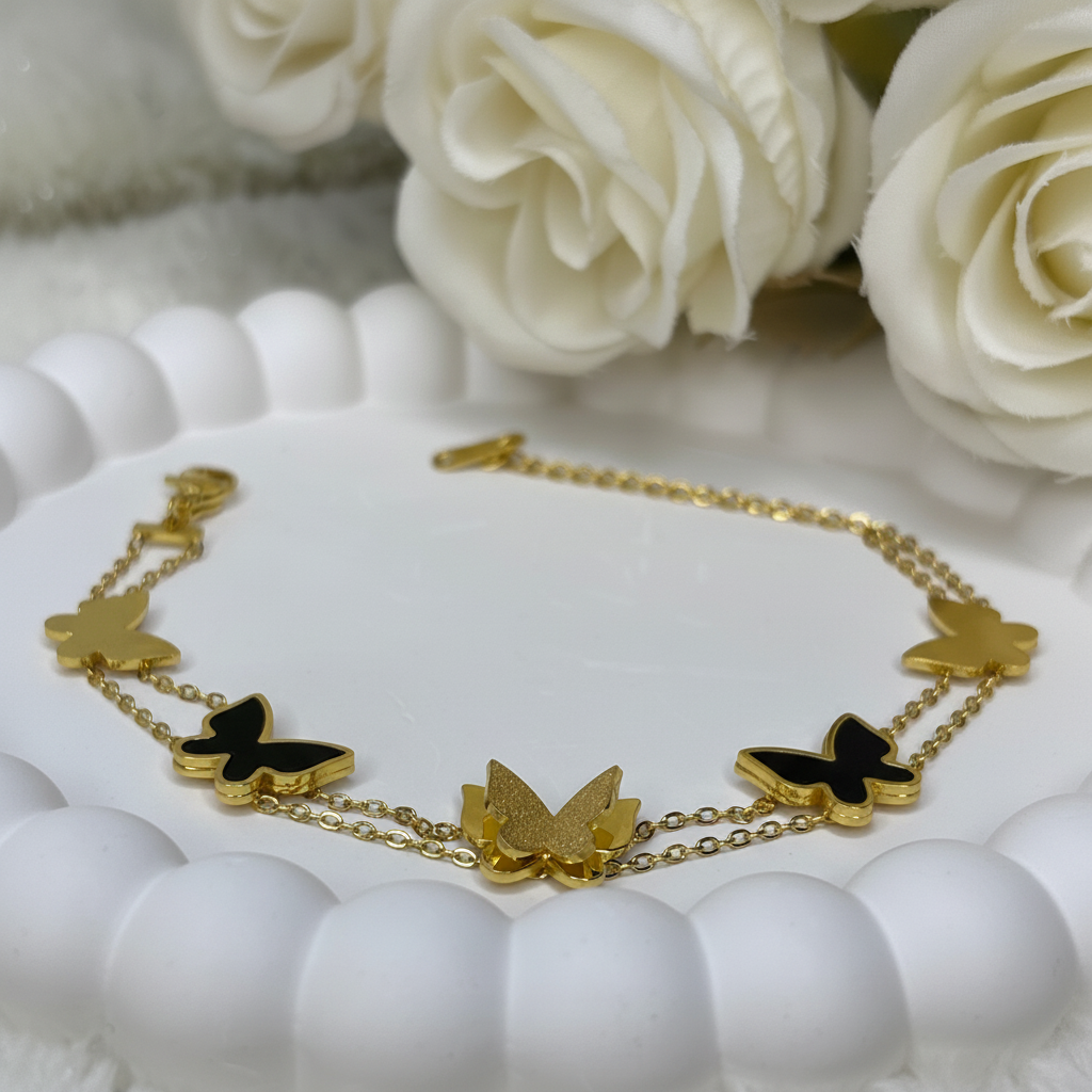 Woman wearing butterfly charm chain bracelet elegant gold bracelet for everyday wear
