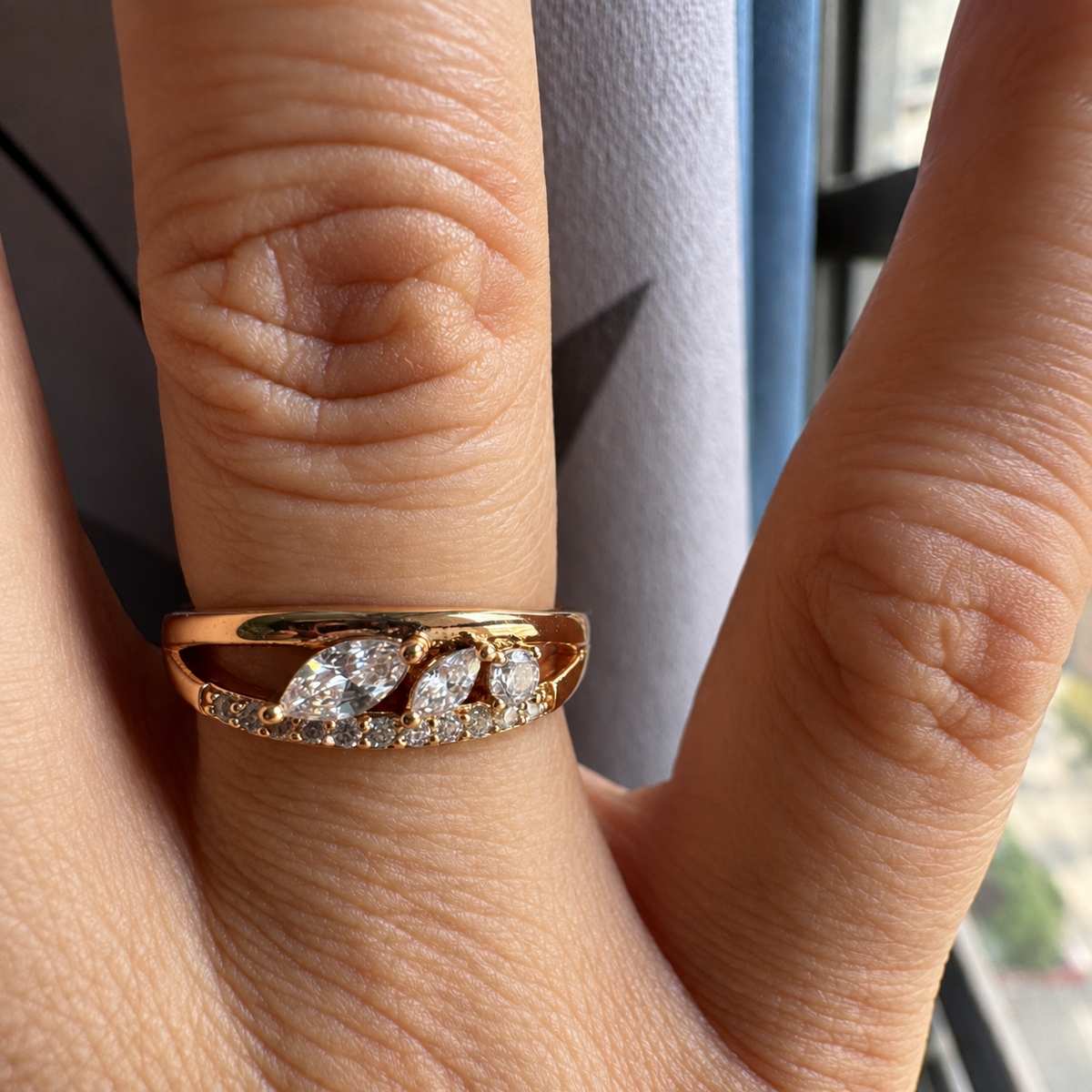 Elara rose gold-tone crystal leaf ring worn on a woman's hand in natural light