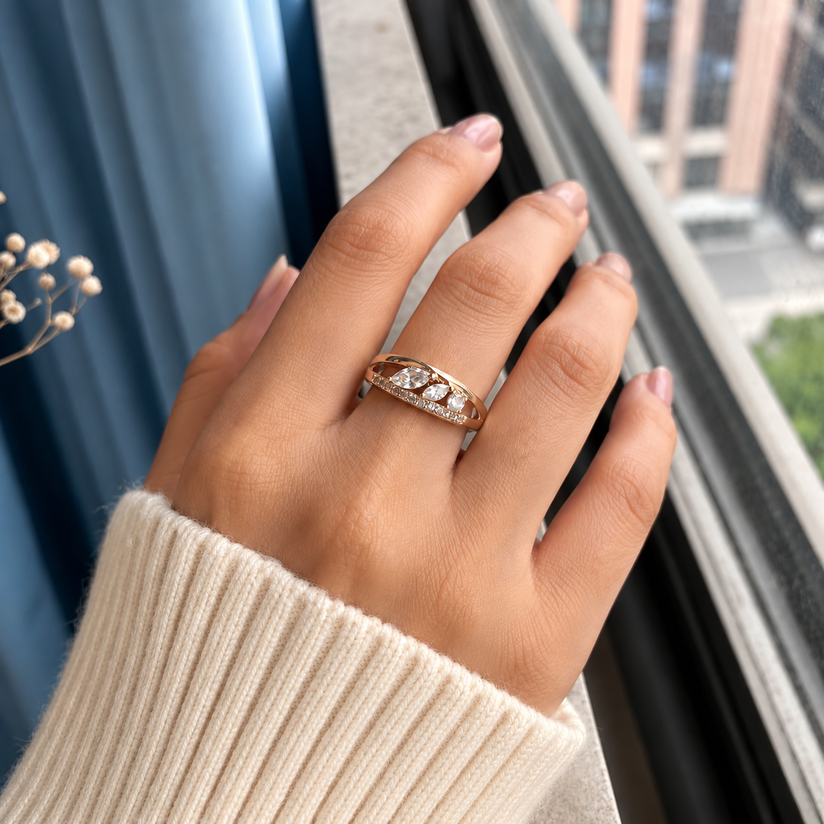 Elara crystal leaf ring in rose gold tone worn on a woman's hand