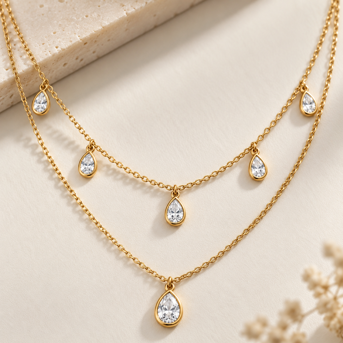 Close-up of Elowyn layered necklace showing fine gold-tone chains and teardrop crystals
