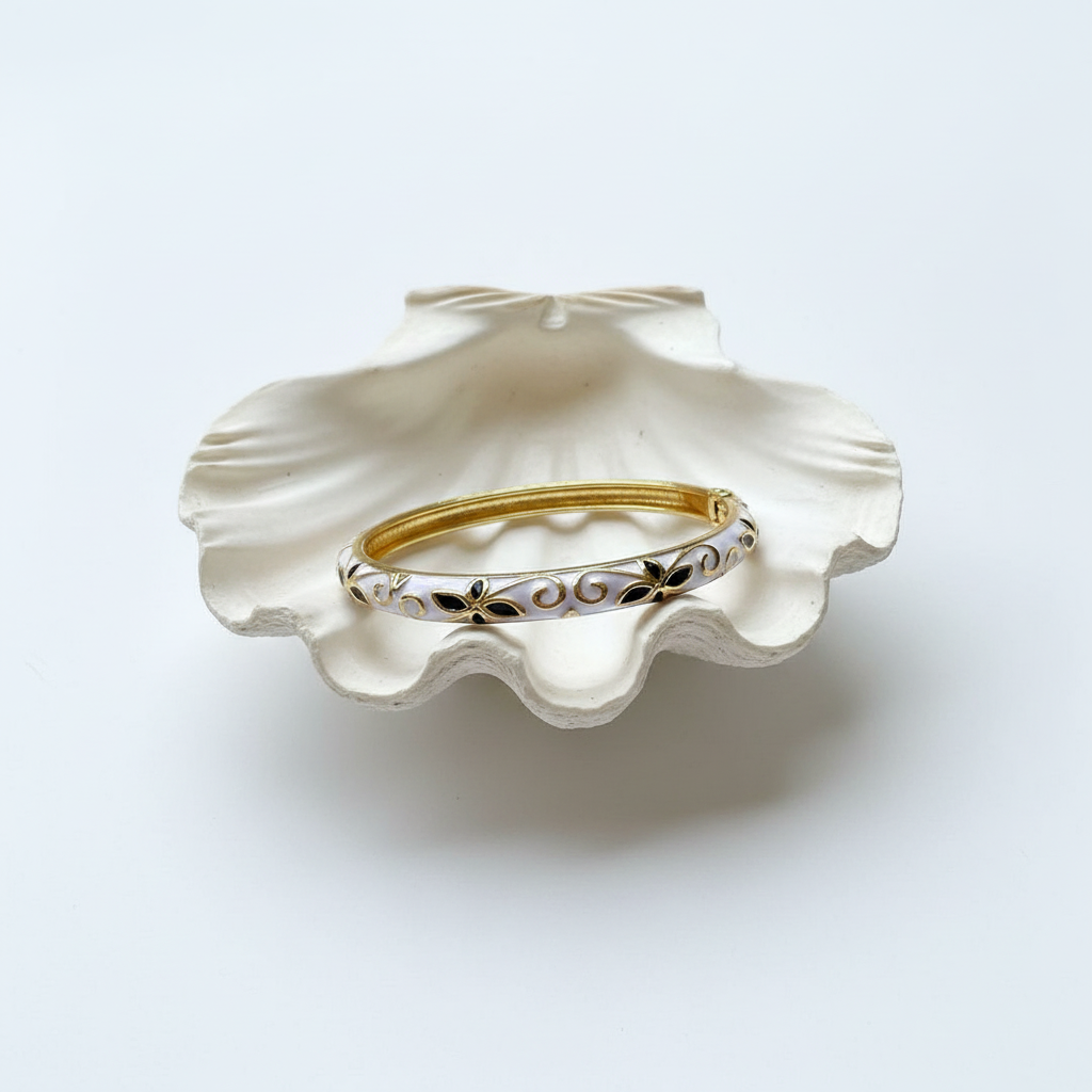 Flat lay of bracelet on shell tray