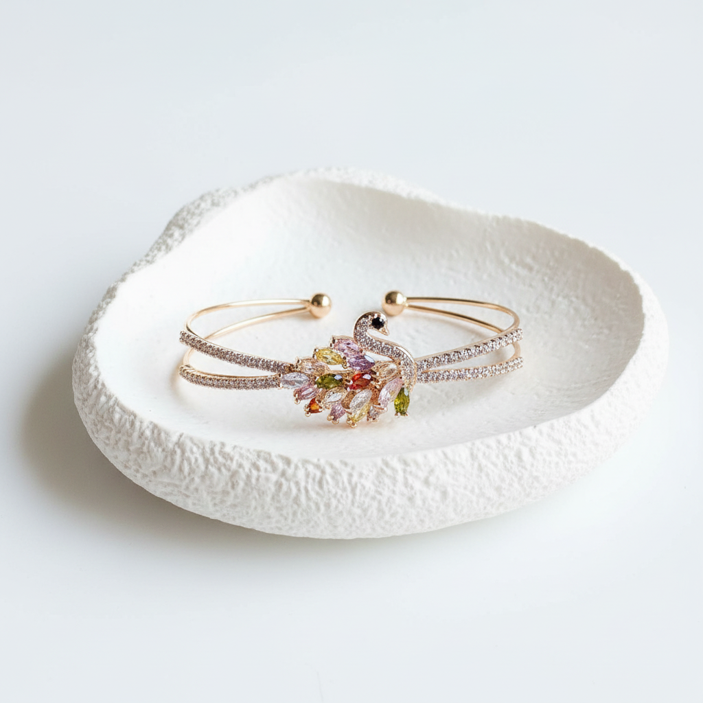 Crystal peacock cuff bracelet flat lay gold peacock bracelet with crystals