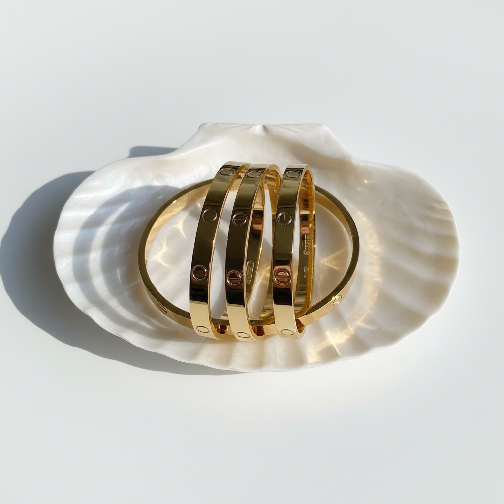 Minimal screw bangle bracelet gold plated bracelet flat lay on white shell tray