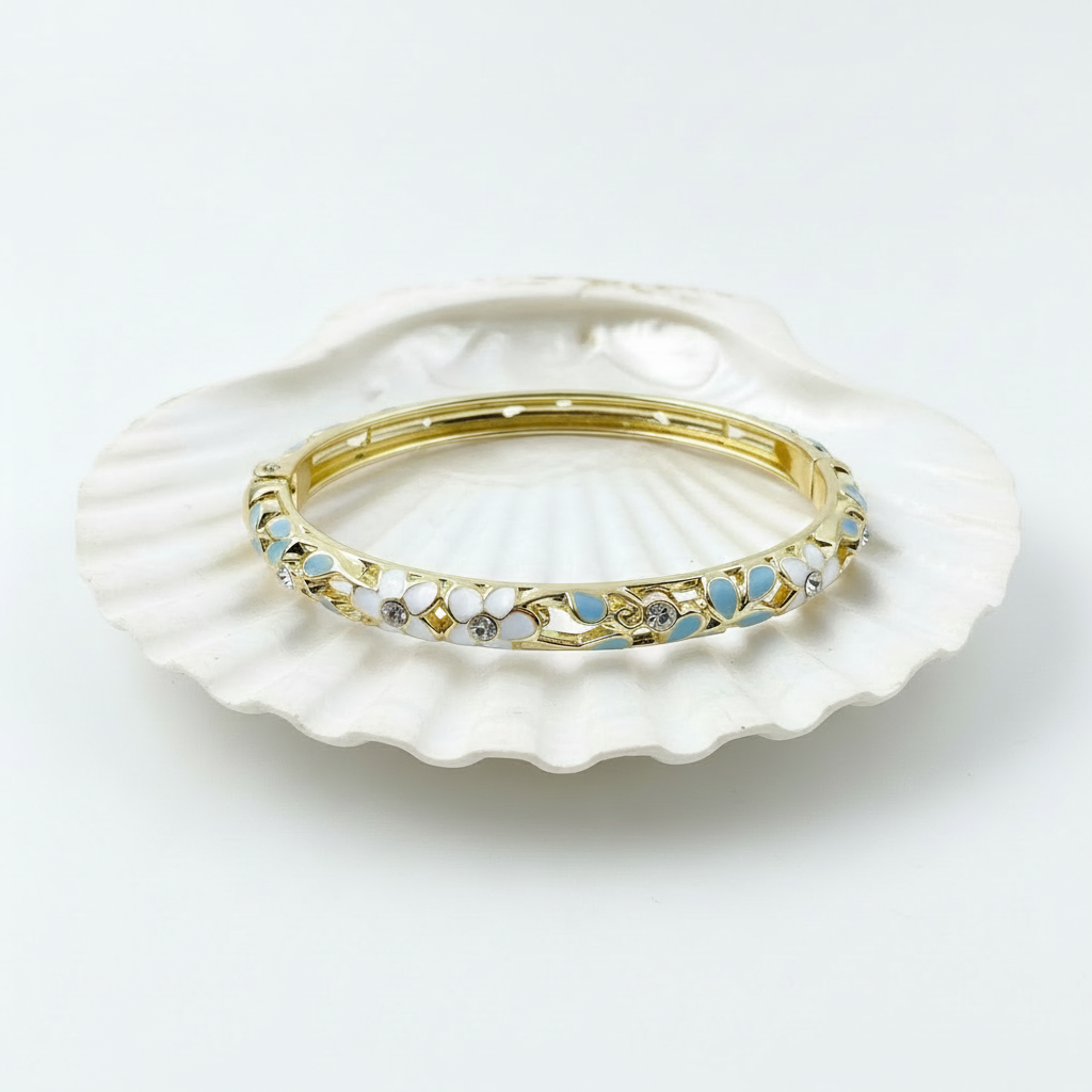 White and blue crystal floral enamel bangle bracelet flat lay gold floral enamel bracelet for women