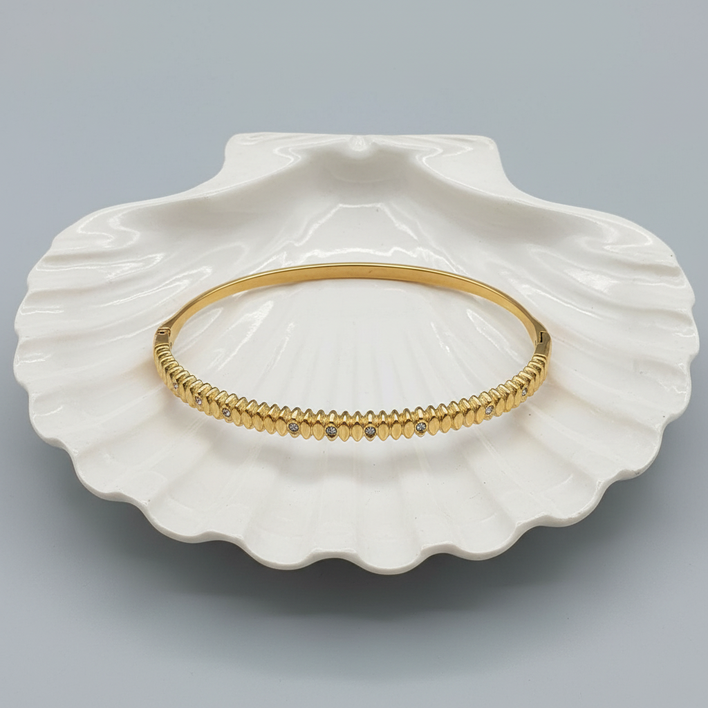 Ribbed Scale Crystal Bangle flat lay in white shell tray