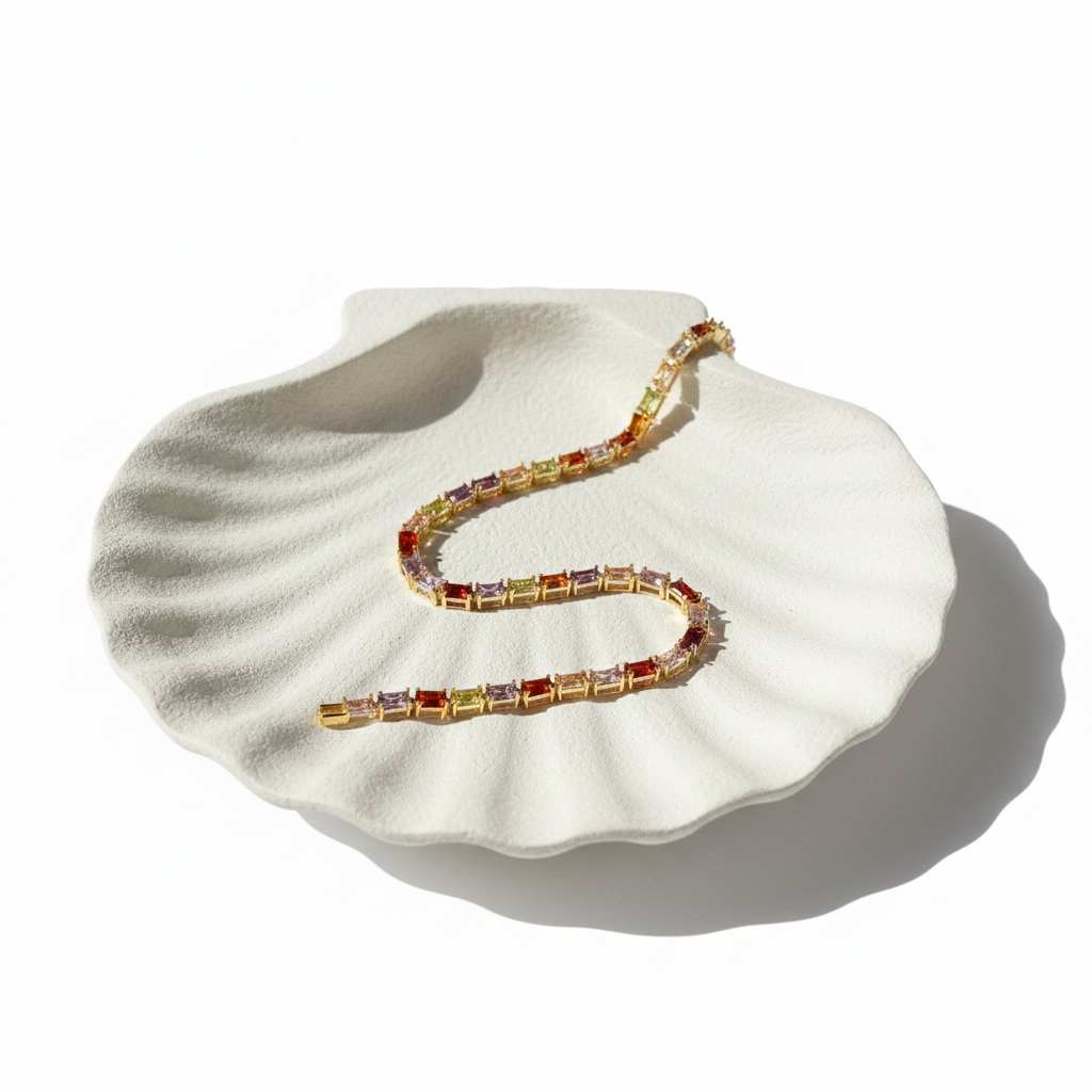 Rainbow Baguette Crystal Tennis Bracelet — flat lay on white shell tray