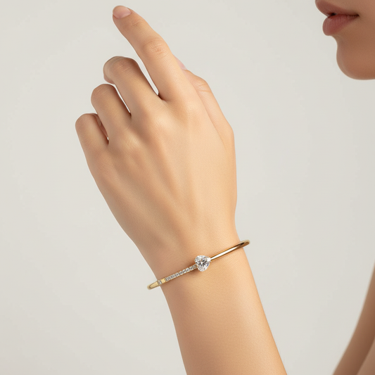 Woman wearing crystal heart pave slim bangle bracelet minimal gold bracelet for everyday wear