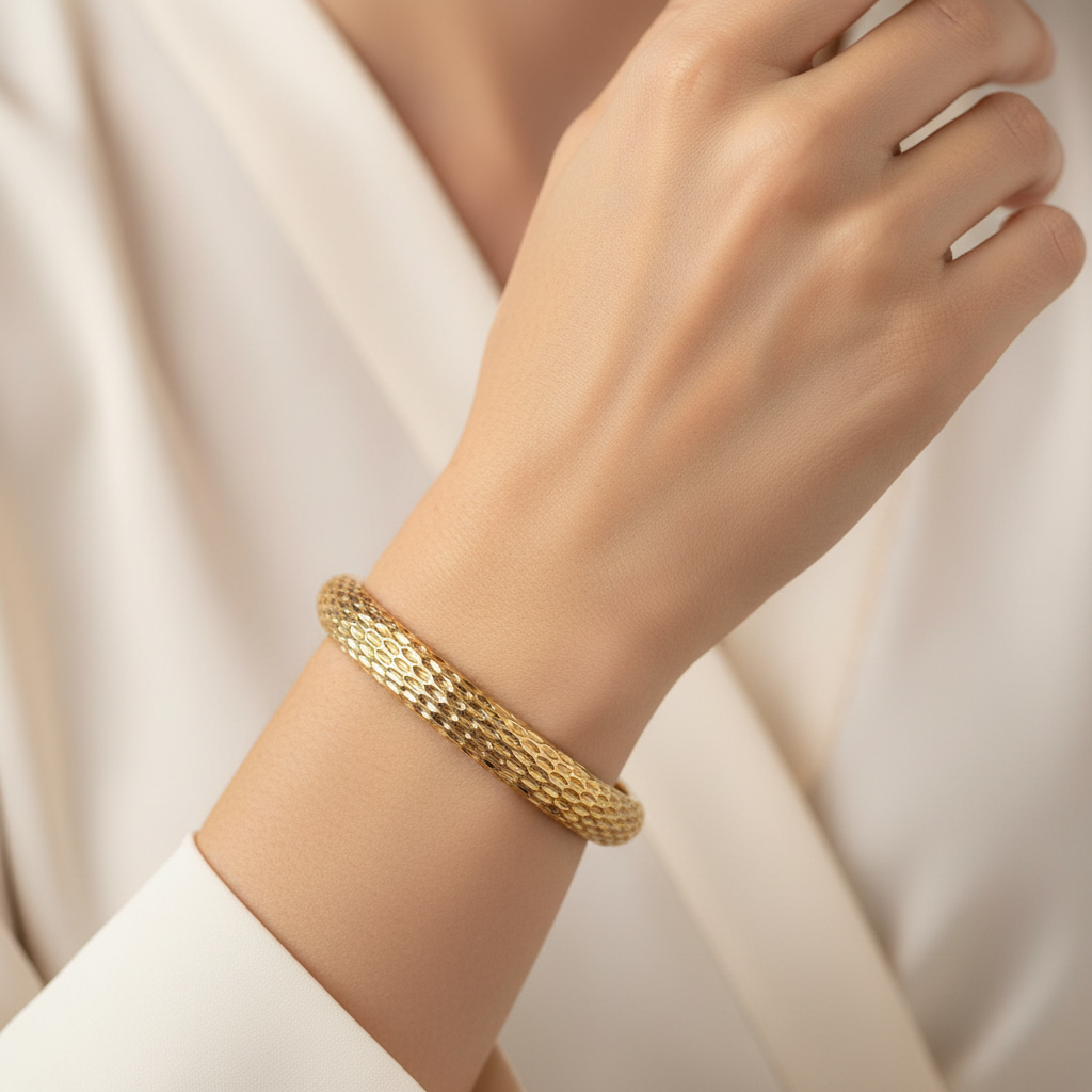 Woman wearing textured gold bangle bracelet elegant everyday bracelet