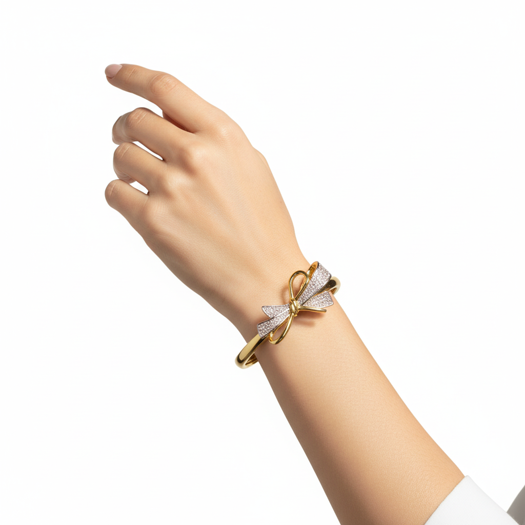 Woman wearing crystal bow cuff bracelet minimal gold bracelet for everyday wear
