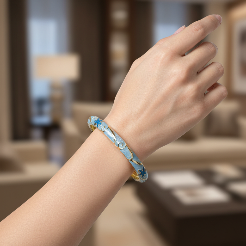 Woman wearing blue floral enamel bangle bracelet minimal gold bracelet for everyday wear