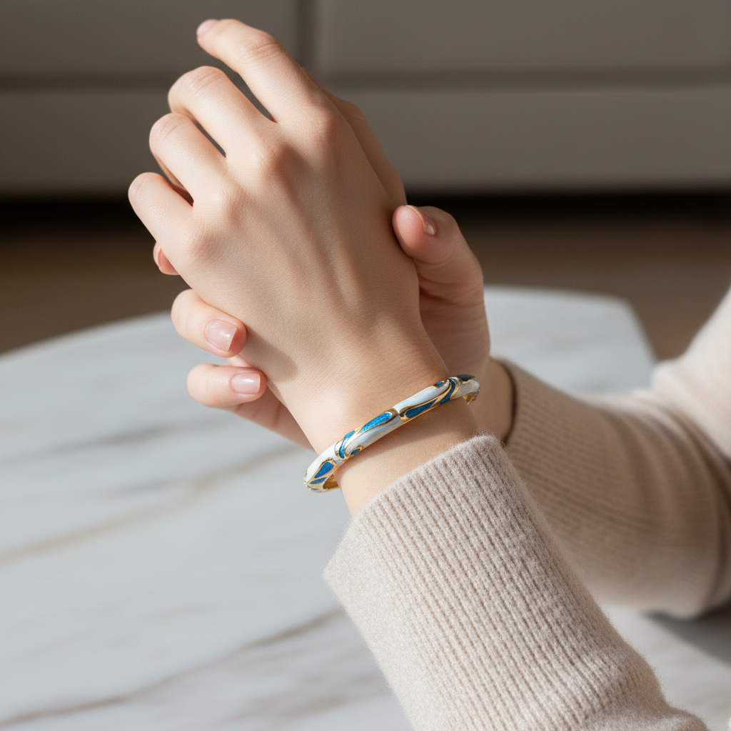 Woman wearing blue and white geometric enamel bangle bracelet minimal gold bracelet for everyday wear