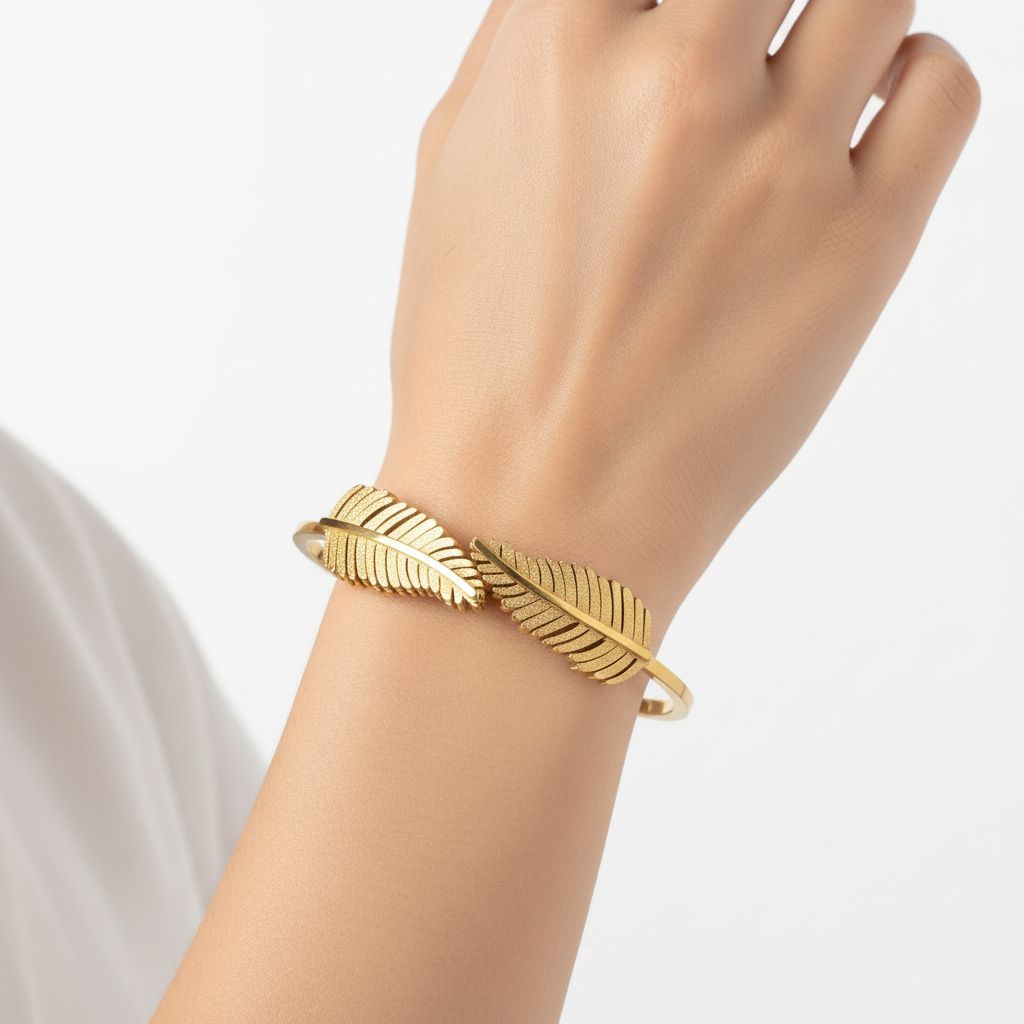 Woman wearing gold plated leaf feather bangle bracelet minimal everyday bracelet for women