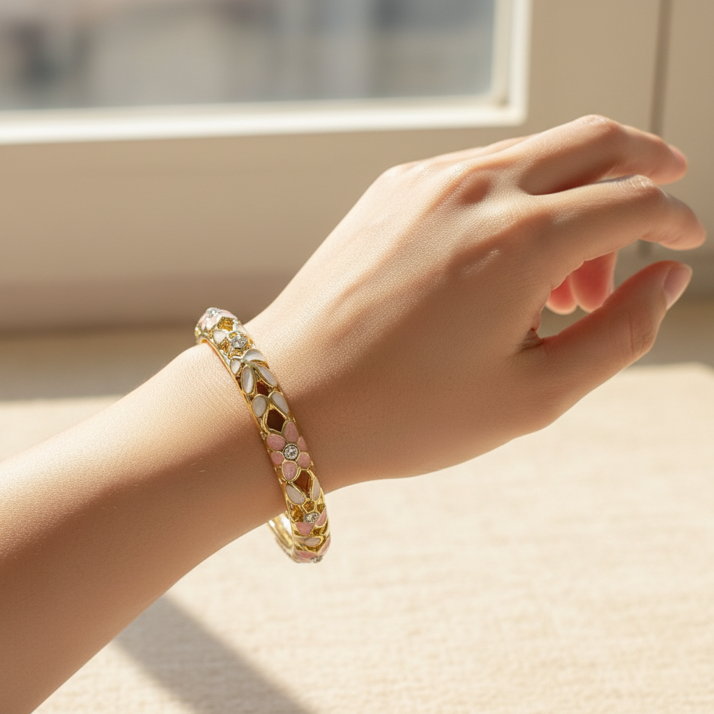 Woman wearing white and pink crystal petal enamel bangle bracelet minimal gold floral bracelet