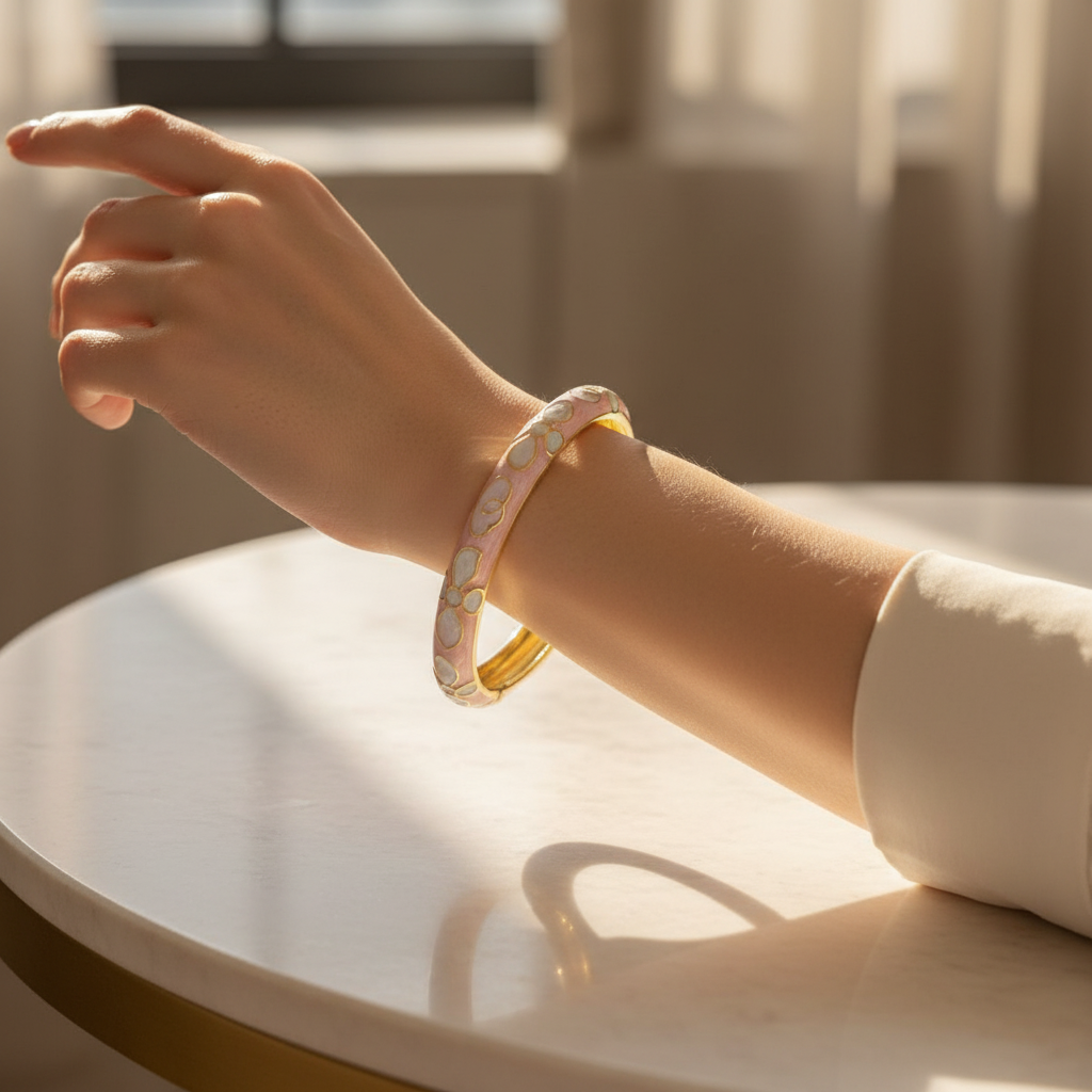 Woman wearing pink petal minimal gold floral bracelet for everyday wear