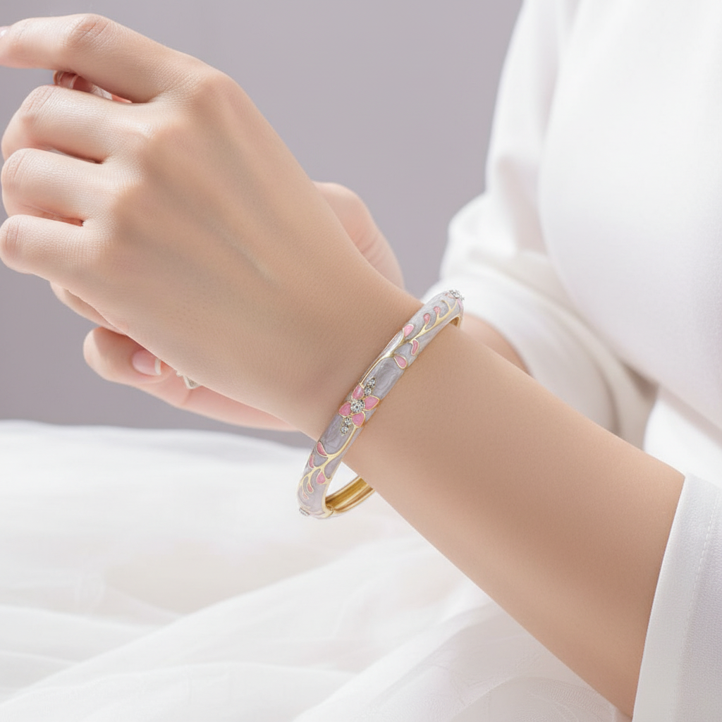 Woman wearing pink lavender crystal floral enamel bangle bracelet minimal gold bracelet for everyday wear