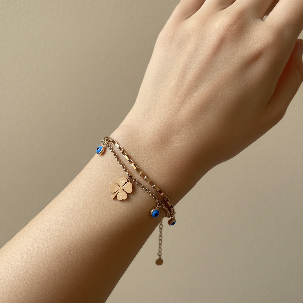 Woman wearing clover evil eye charm bracelet minimal gold everyday bracelet