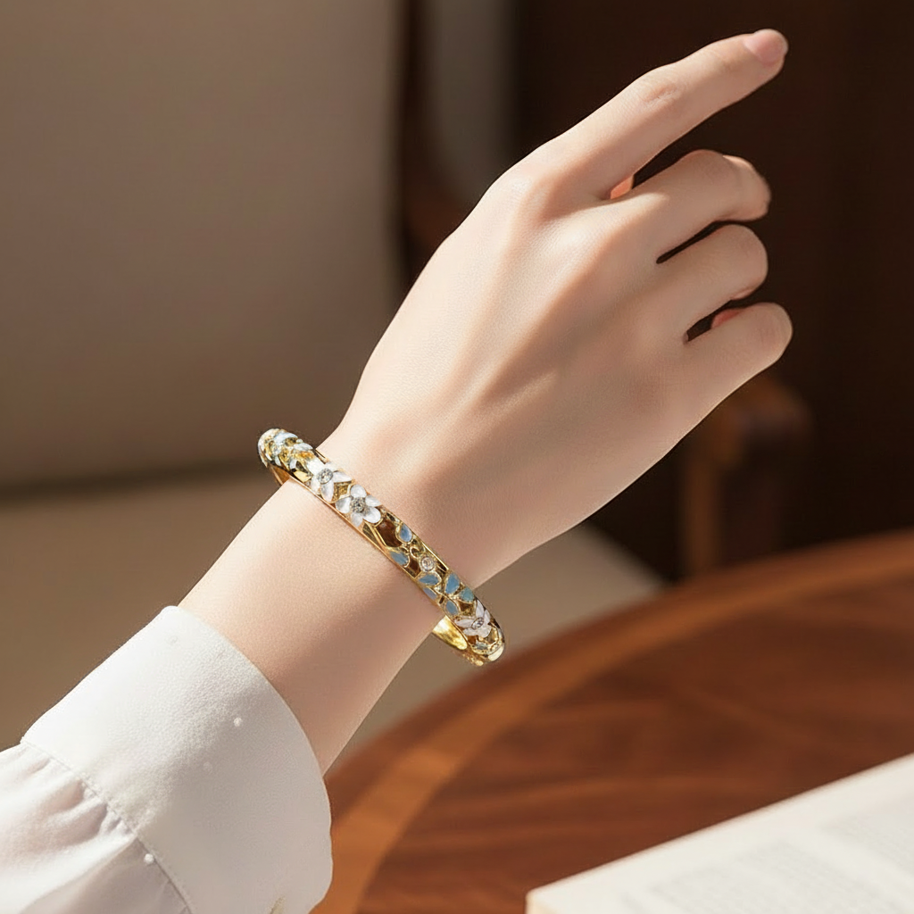 Woman wearing white and blue crystal floral enamel bangle bracelet minimal gold bracelet for everyday wear