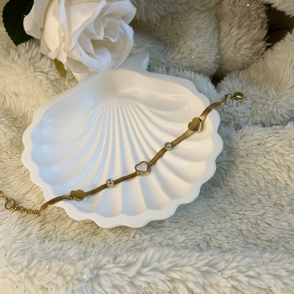 Heart and crystals snake chain gold plated crystal heart bracelet for women on white background